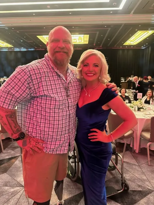 VETCOMM CEO Kate Monroe with para athlete and veteran Brian “Big Country” Conwell at a formal event celebrating veteran leadership and resilience.