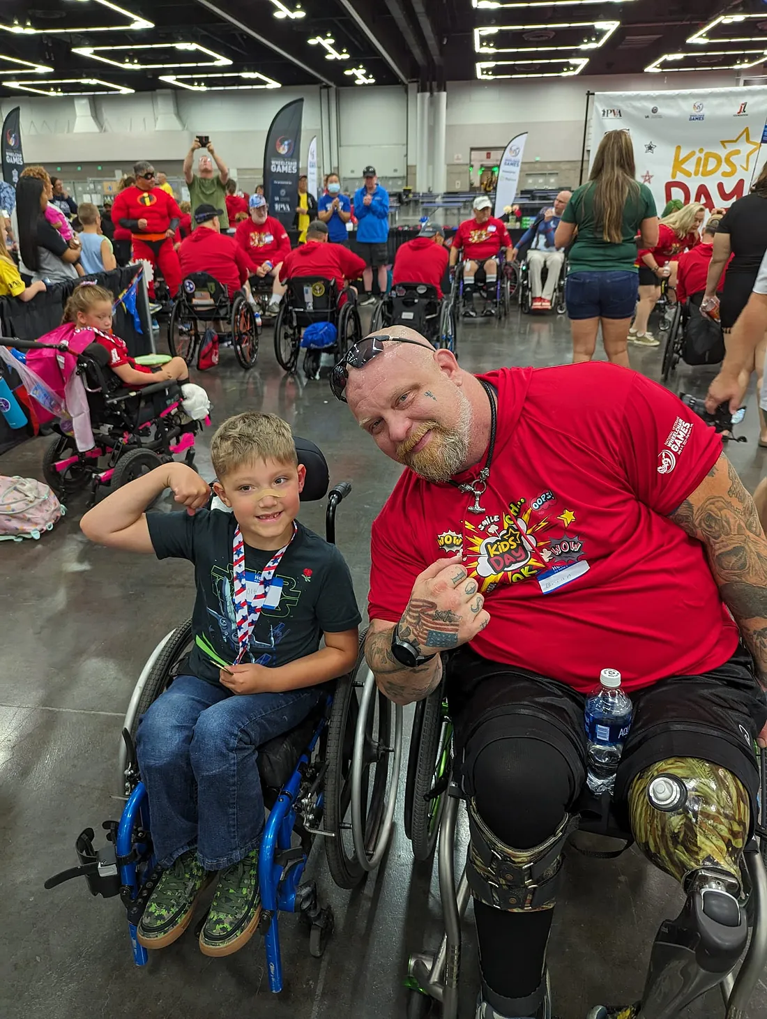 Para athlete and veteran Brian “Big Country” Conwell poses with a fan at a veteran-focused event, celebrating resilience and community.