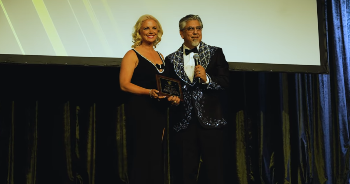 Kate Monroe receiving the Veteran Media Advocate Award at the 2025 Military & Veterans Entertainment Awards Gala